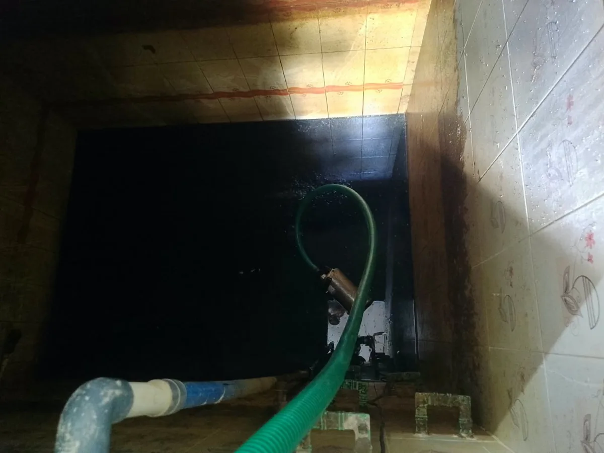 Muddy and dirty water sump before cleaning with accumulated sludge